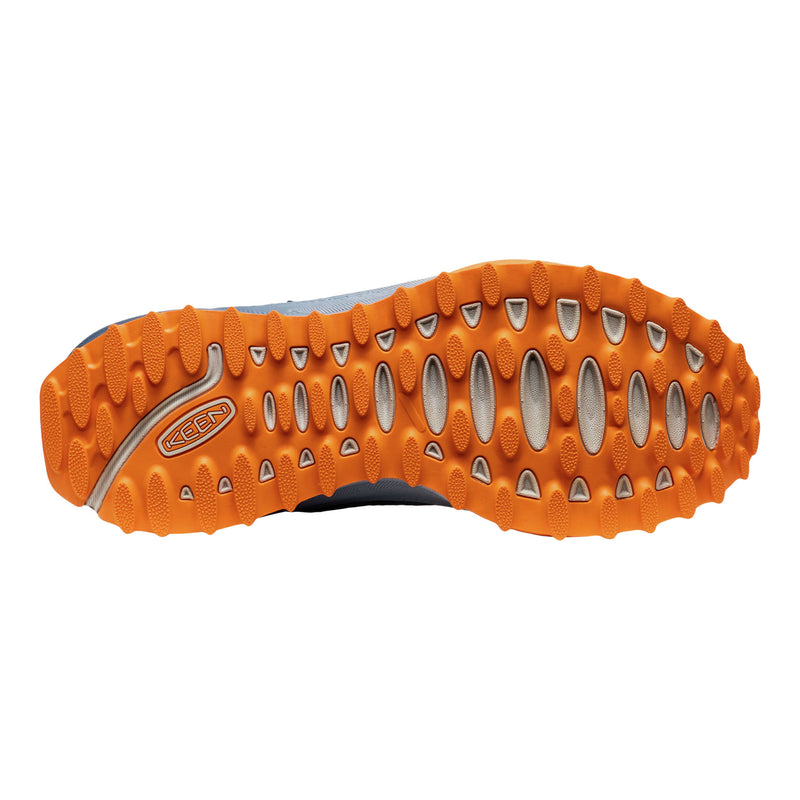 Close-up of an orange shoe sole with a brand logo on a white background