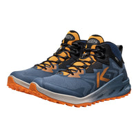 Blue and orange running shoes with Kari Traa logo on a white background
