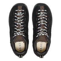 A pair of black suede and mesh low-top sneakers with white braided laces, shown from a top-down view on a white background. The interior lining is beige with the brand name 'SKAL' printed on it.