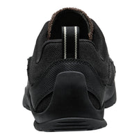 A black slip-on shoe with a textured mesh upper, a thick black sole, and a brown fuzzy lining visible at the collar, shown from a rear three-quarter view on a white background.
