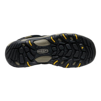 Black and yellow Keen shoe sole on a white background