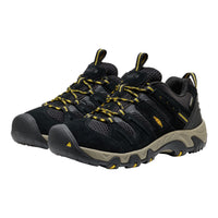 Black and beige hiking shoes with yellow accents on a white background