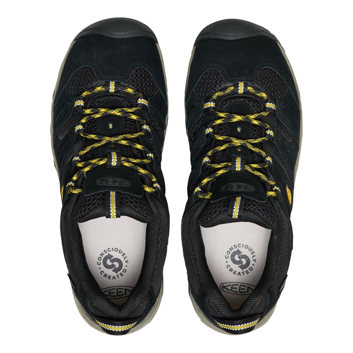 Black hiking shoes with yellow laces on a white background
