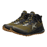 Pair of green and black hiking boots on a white background