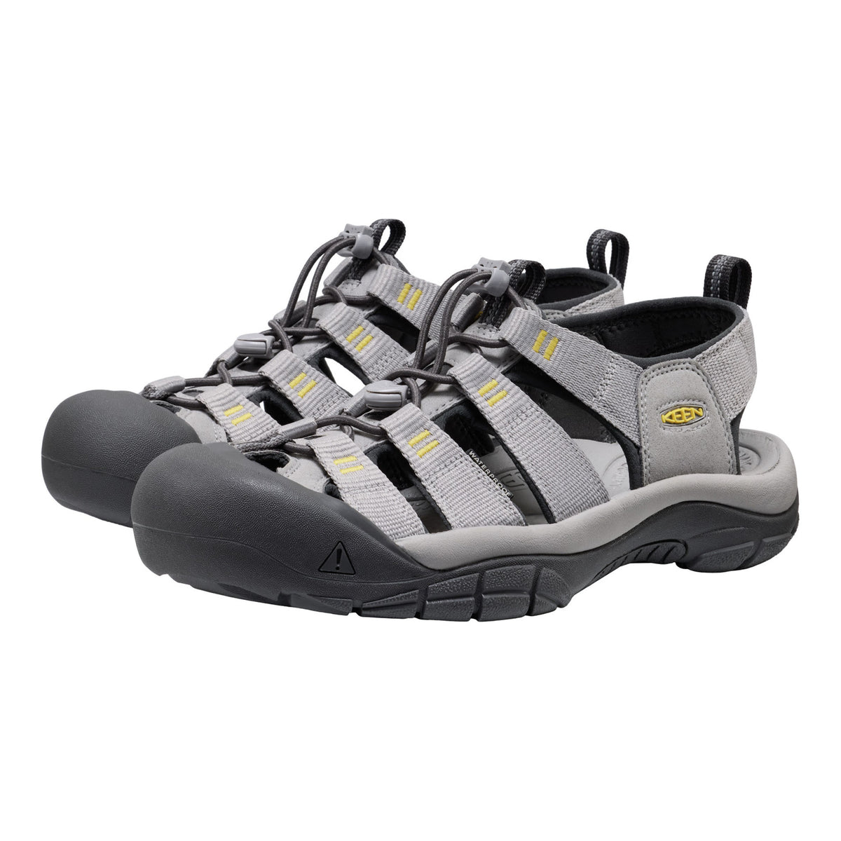 Pair of gray and black sandals with yellow accents on a white background