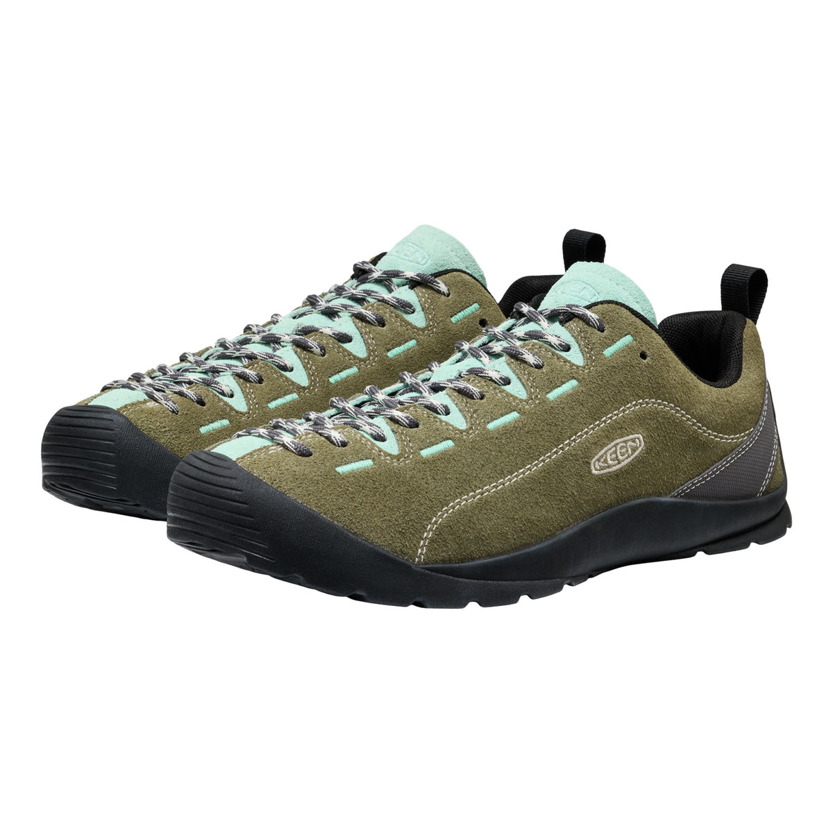 Pair of green hiking shoes with black soles on a white background
