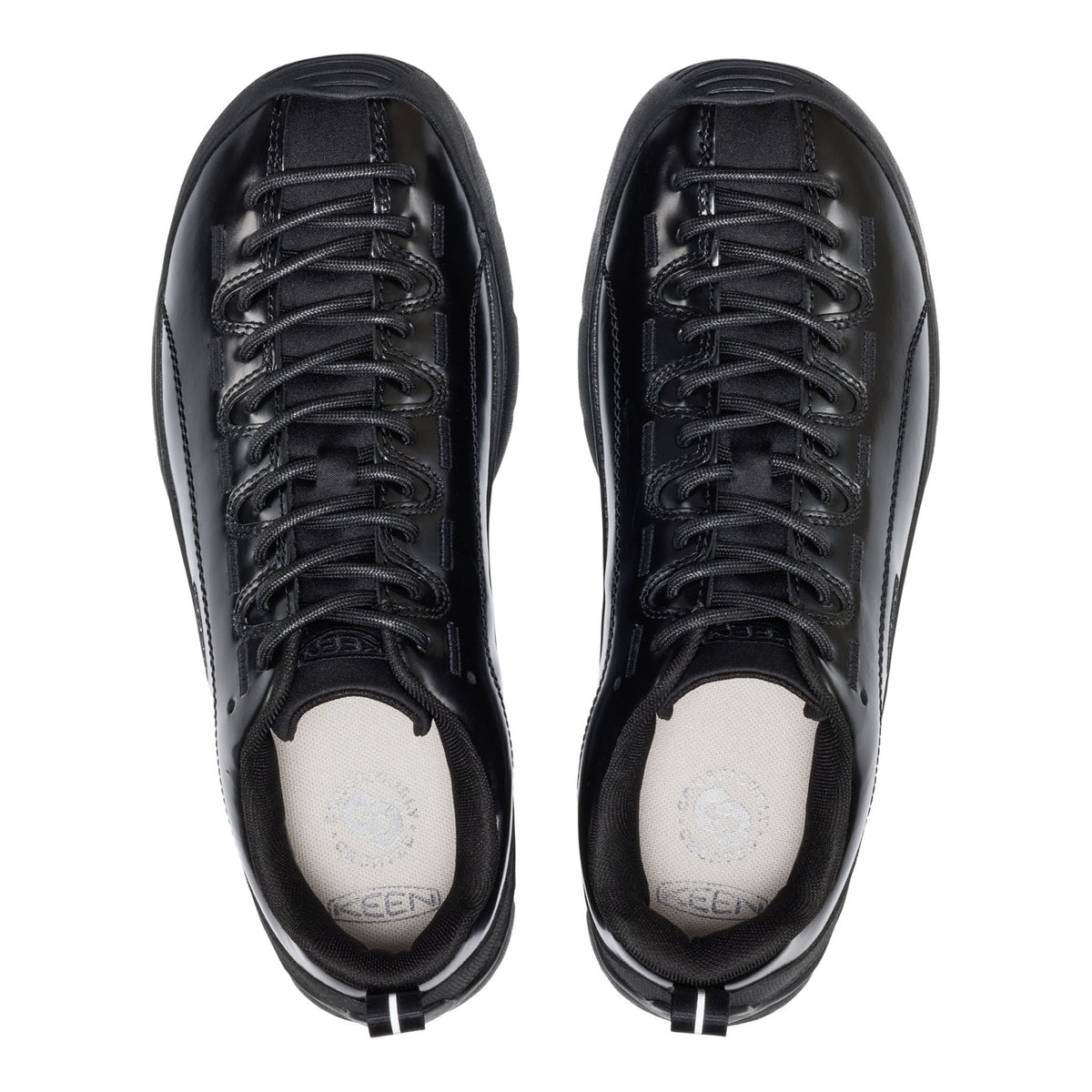 Black sneakers with white soles on a white background