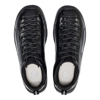 Black sneakers with white soles on a white background