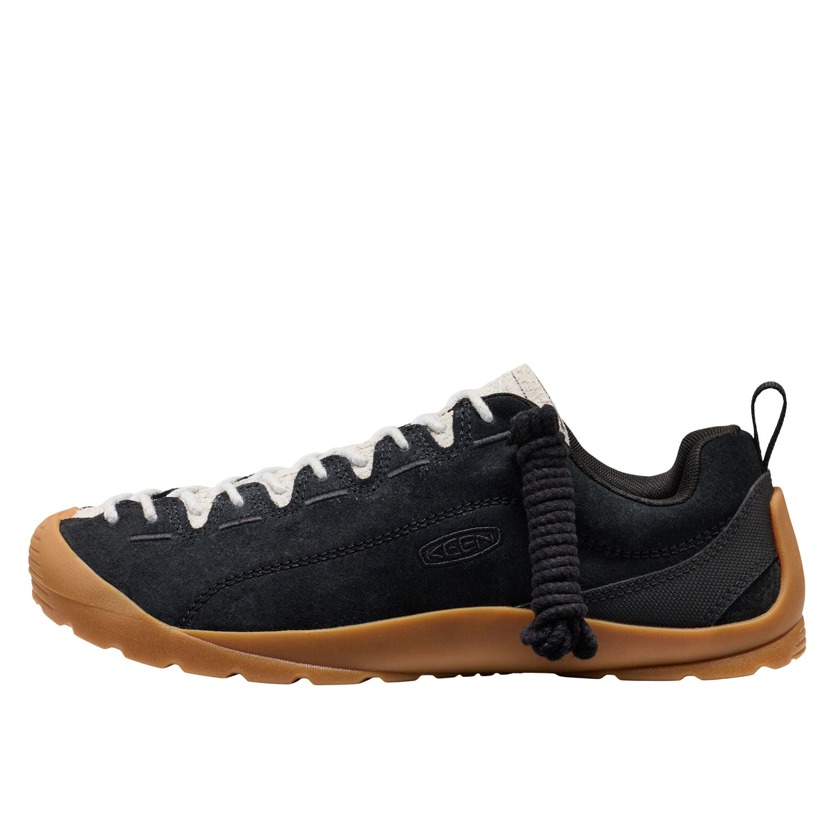 Black sneaker with brown sole on a white background