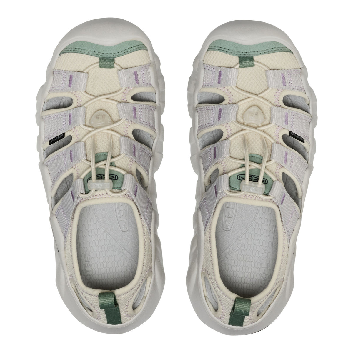 Pair of white and green sandals on a white background