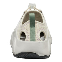 White shoe with a green strap on a white background