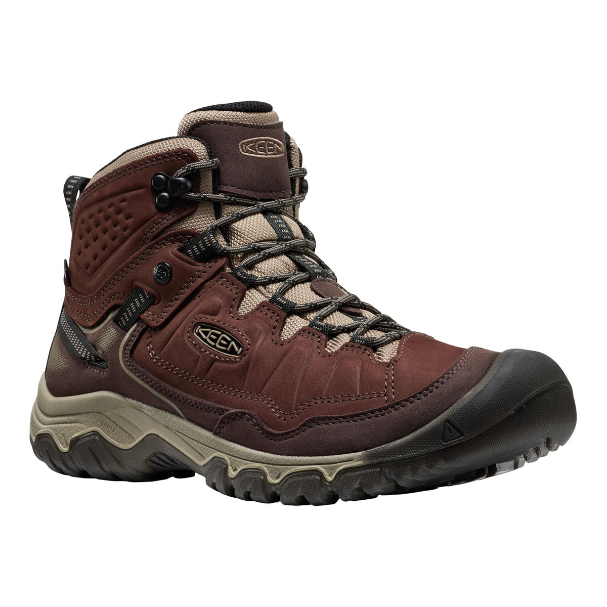 A Keen mid-height hiking boot in dark brown and beige, featuring a lace-up front, textured synthetic upper, and a rugged black and beige sole, shown against a plain white background.