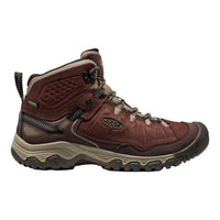 A Keen mid-cut hiking boot in dark brown and beige, featuring a lace-up front, textured synthetic and leather panels, and a rugged sole, shown against a plain white background.