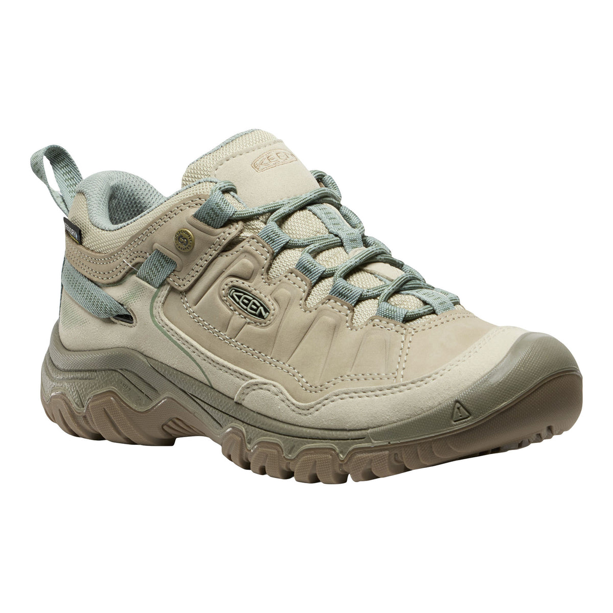 Beige hiking shoe with green accents on a white background