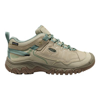 Beige hiking shoe with teal accents on a white background