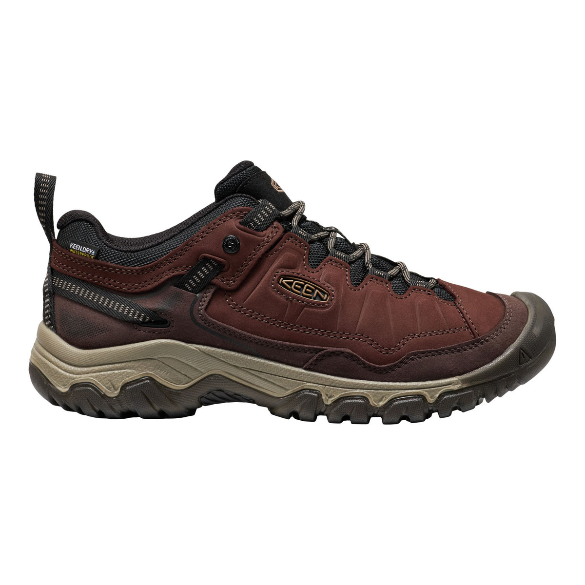 A Keen hiking shoe in dark brown and black with a beige midsole, shown in a side profile view against a white background.