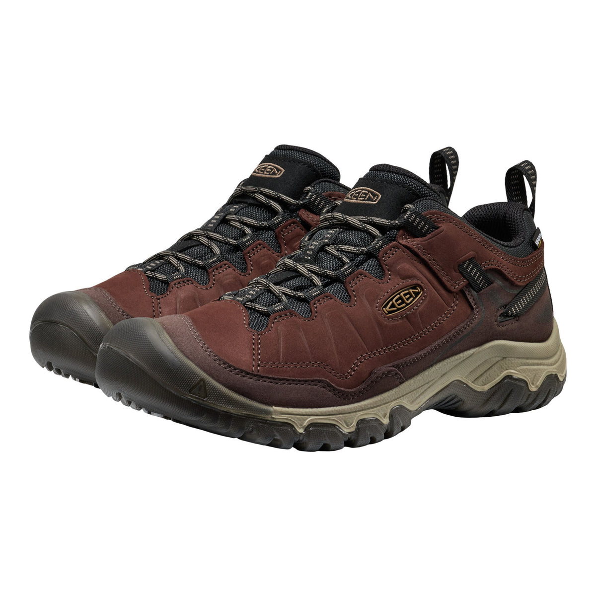 A pair of Keen hiking shoes in dark brown and black with a beige midsole, shown on a plain white background.
