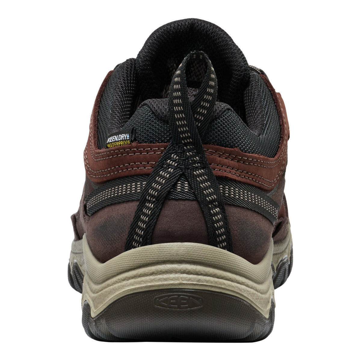 A close-up rear view of a Keen hiking shoe in brown and black with a beige midsole, on a white background.