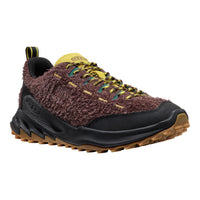 Brown and black sneaker with yellow accents on a white background