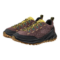 Pair of brown and yellow hiking shoes on a white background