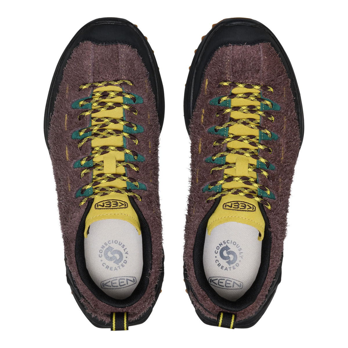 Pair of Keen hiking shoes with brown suede upper, yellow laces, and white soles on a white background.