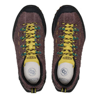 Pair of Keen hiking shoes with brown suede upper, yellow laces, and white soles on a white background.