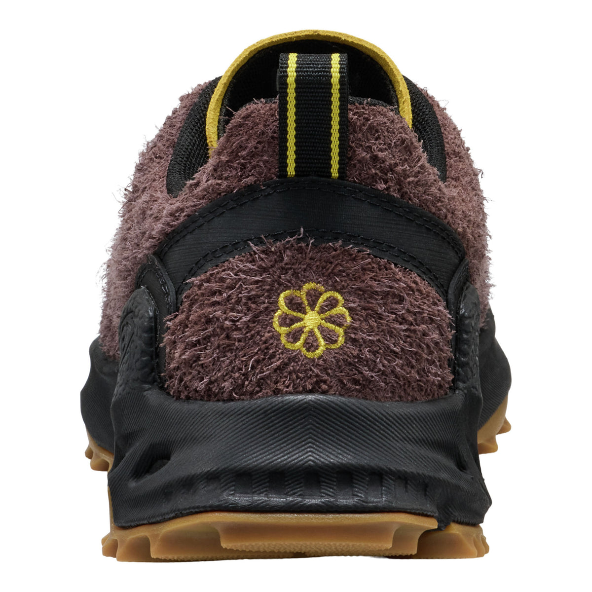 Back view of a shoe with fuzzy brown accents and yellow flower design on a white background