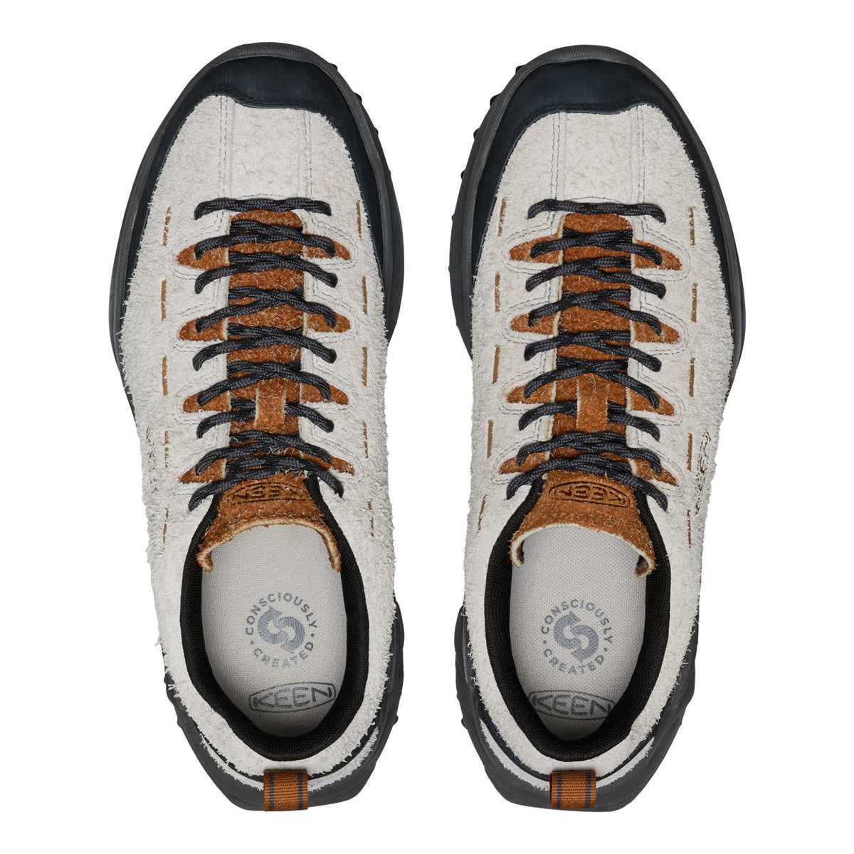 Pair of white sneakers with brown and black accents on a white background