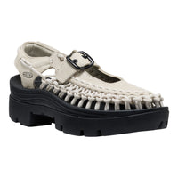 White sandal with black sole on a white background