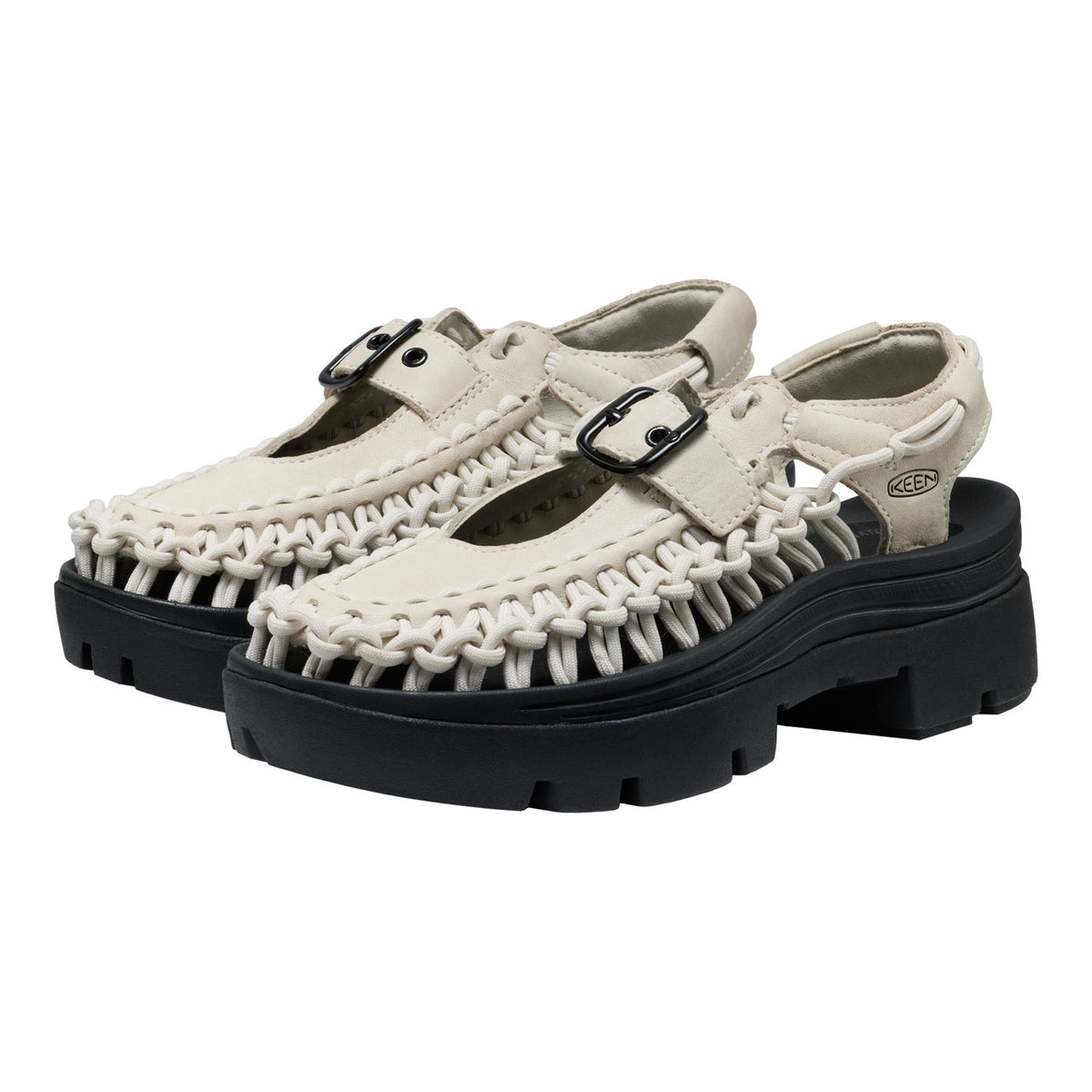 Pair of white sandals with black soles on a white background