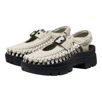 Pair of white sandals with black soles on a white background