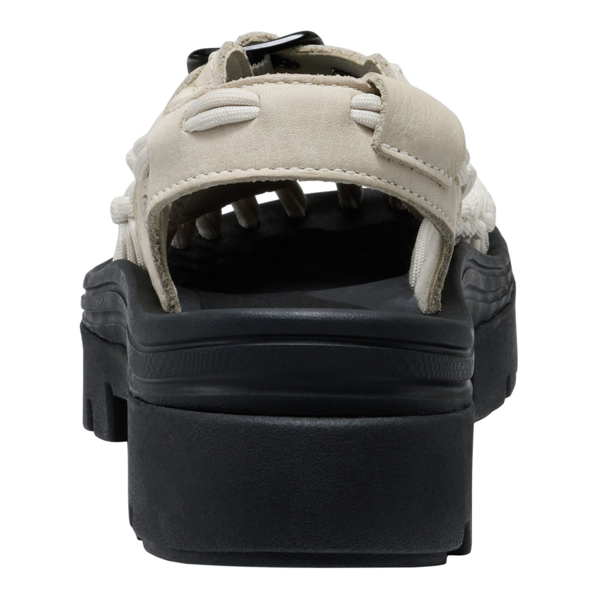 Black sandal with beige suede straps on a white background