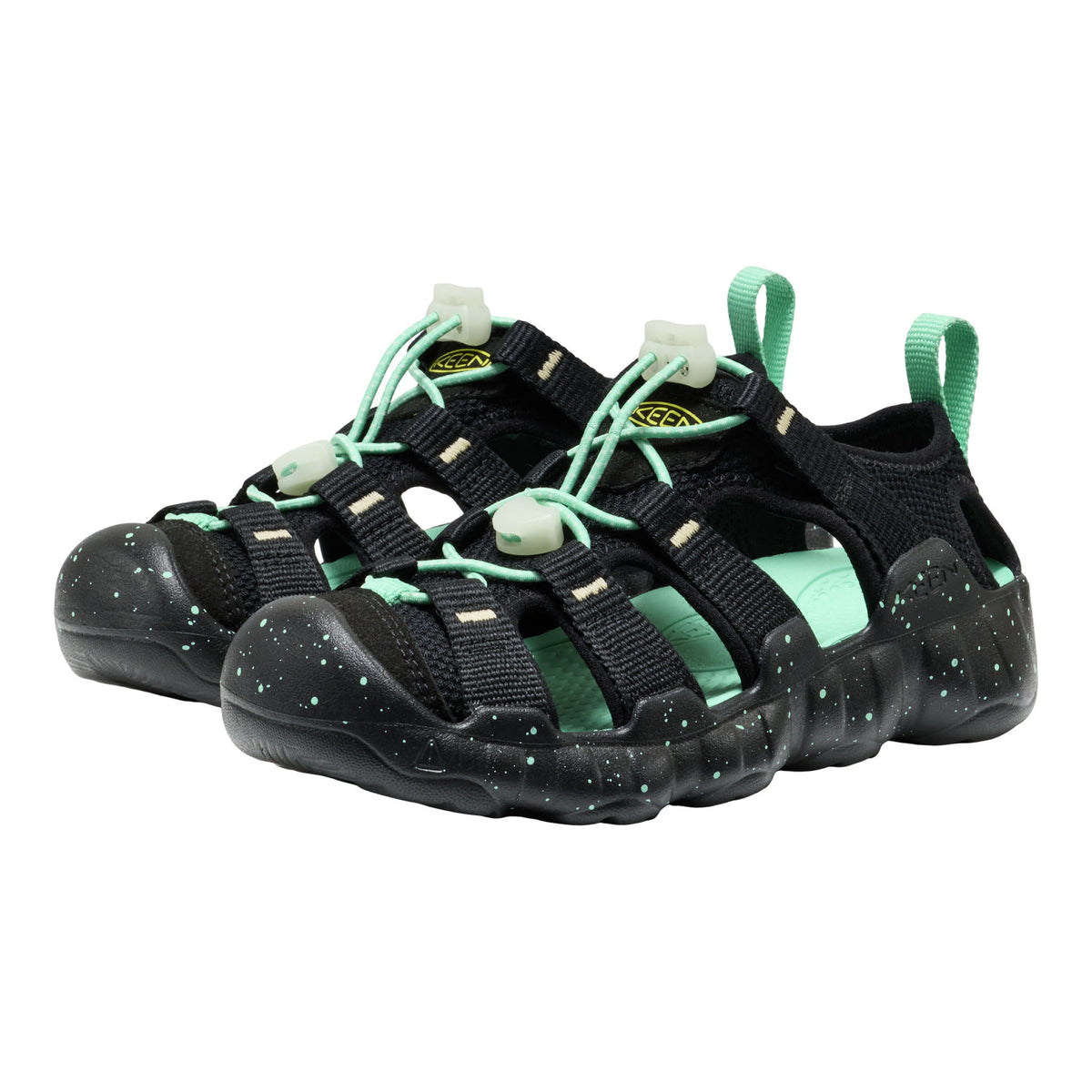 Black and green sandals with velcro straps on a white background