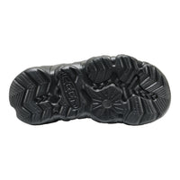 The black kids keen textured rubber outsole of a shoe, showing deep tread patterns, photographed from a top-down view on a white background.