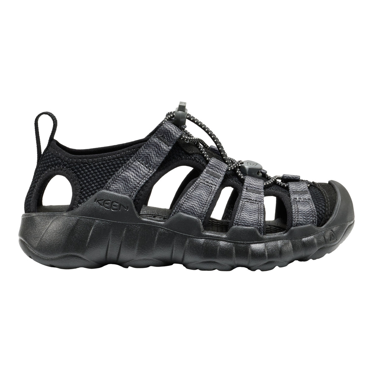 A black kids Keen sandal with multiple adjustable straps and a thick textured sole, shown in a side profile on a white background.