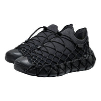 Black woven sneakers on a white background