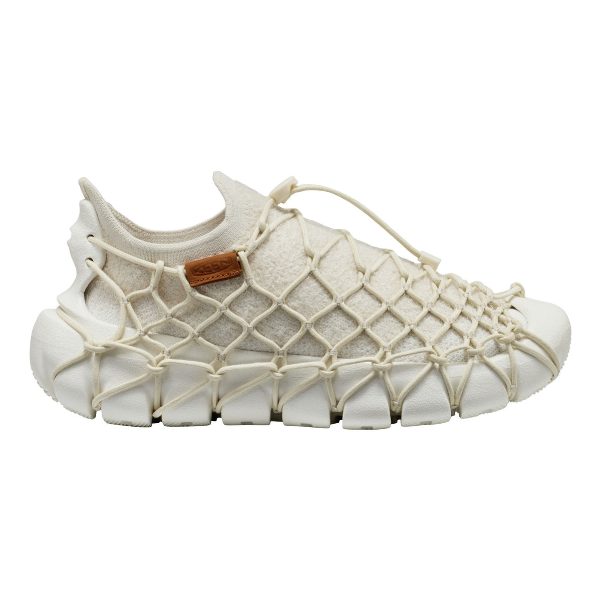 White mesh shoe with a brown label on a white background