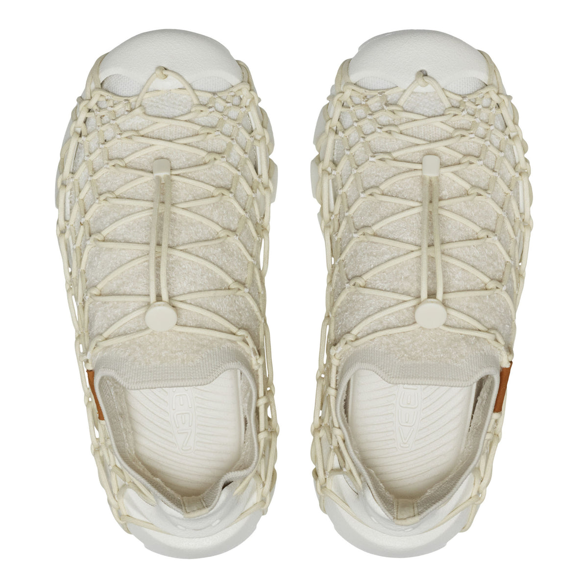 Pair of beige sandals with woven design on a white background