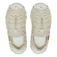 Pair of beige sandals with woven design on a white background