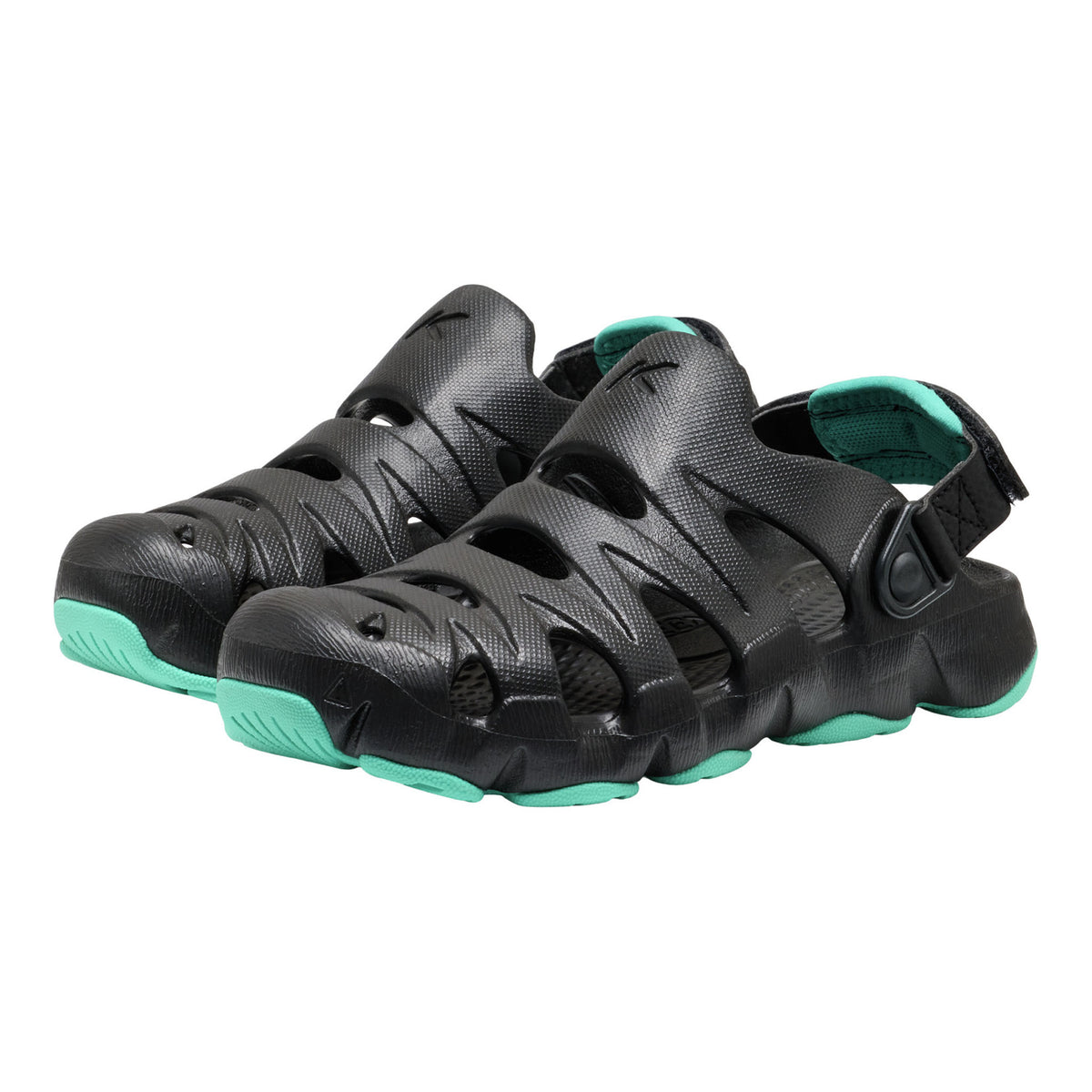 Black sandals with green soles on a white background