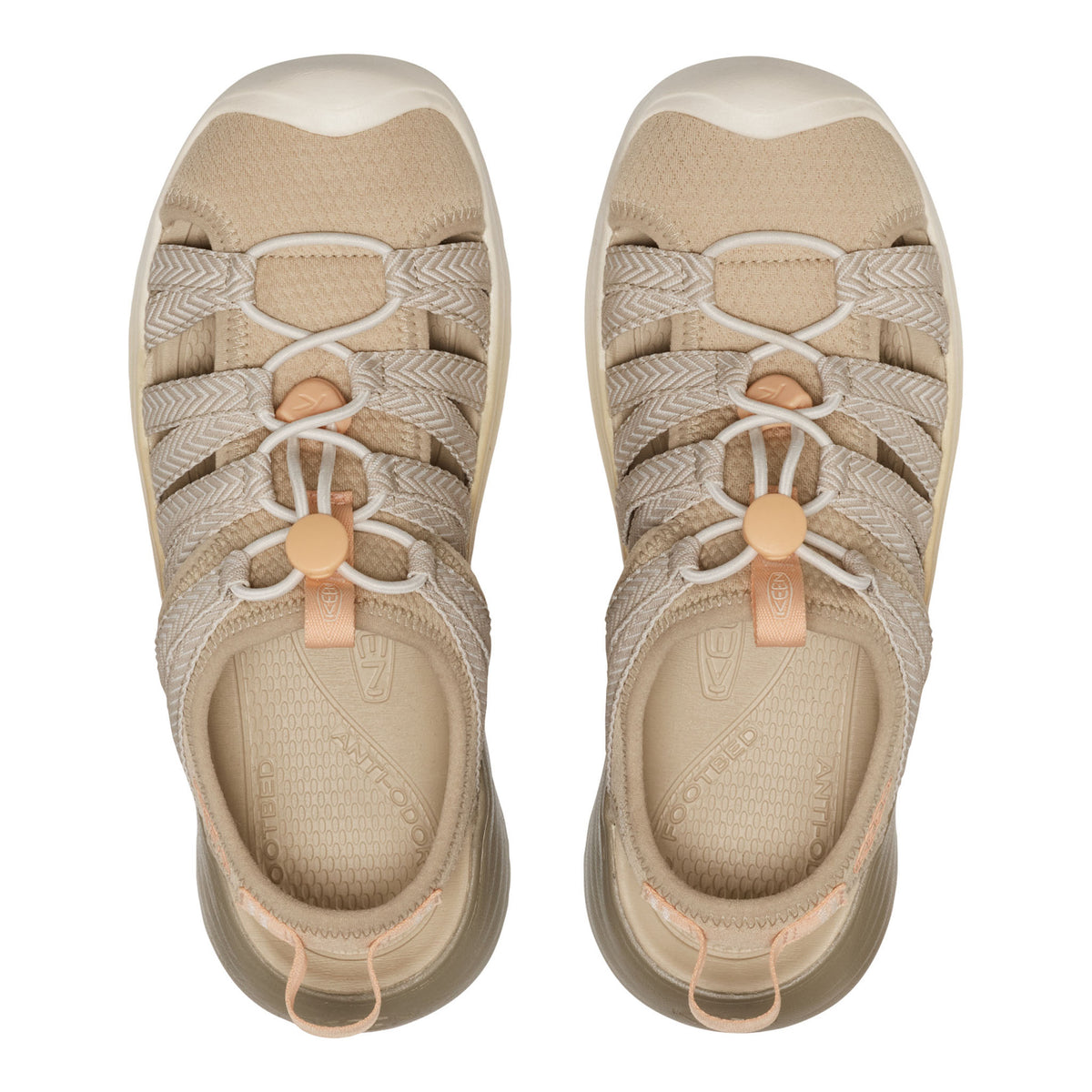 Pair of beige sandals with brown straps on a white background