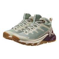 Light blue and beige hiking shoe with brown sole on a white background