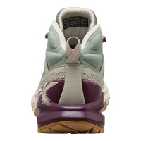 Back view of a sneaker with purple sole and beige accents on a white background