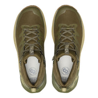 Pair of olive green sneakers with white soles on a white background