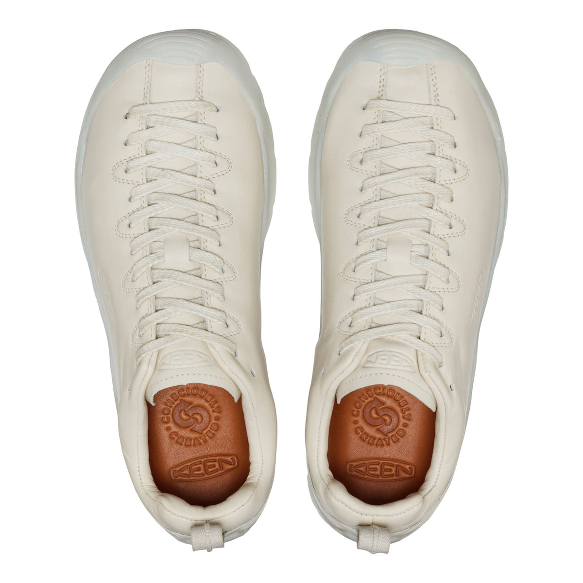Pair of white sneakers with brown soles on a white background