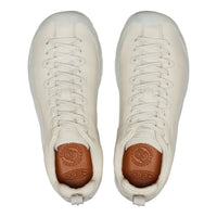 Pair of white sneakers with brown soles on a white background