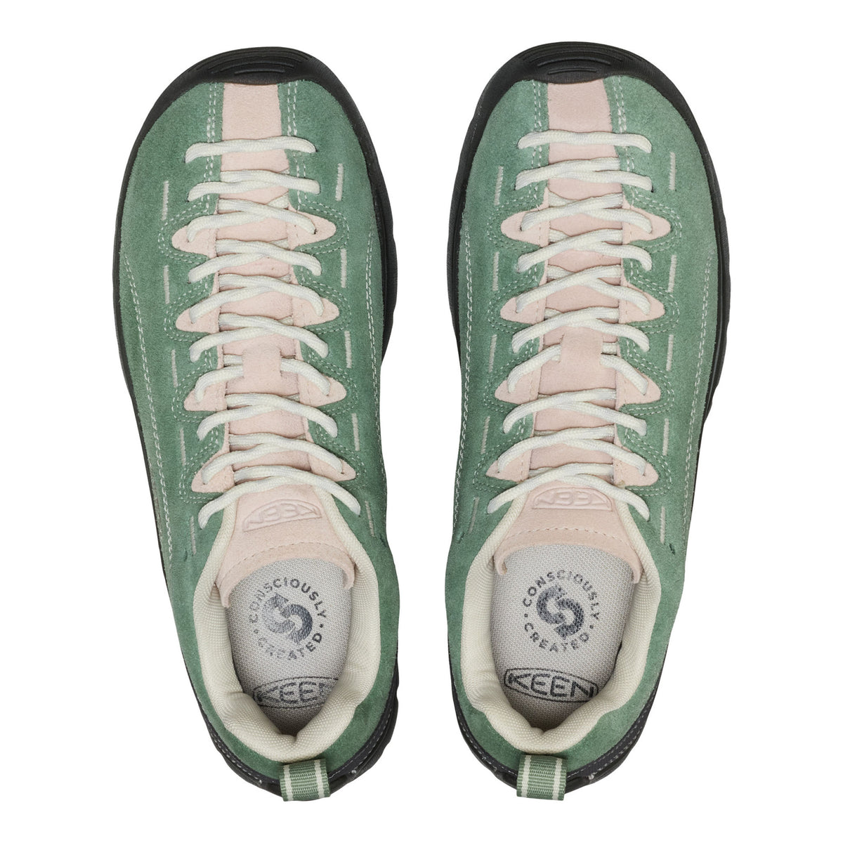 Green sneakers with pink laces on a white background