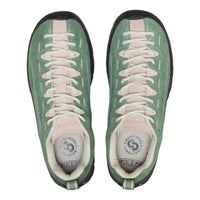 Green sneakers with pink laces on a white background