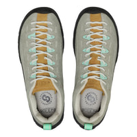Pair of grey sneakers with tan and green accents on a white background