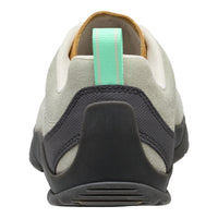 Back view of a grey and black sneaker with a green pull tab on a white background